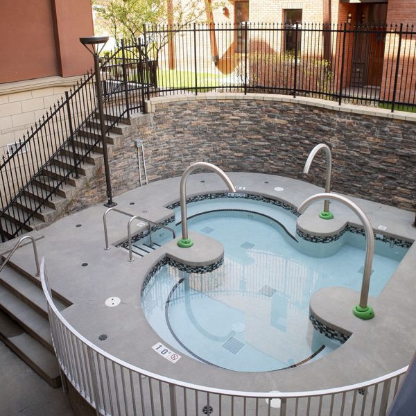 Clear water of Spa 901 hot pool with tree in background